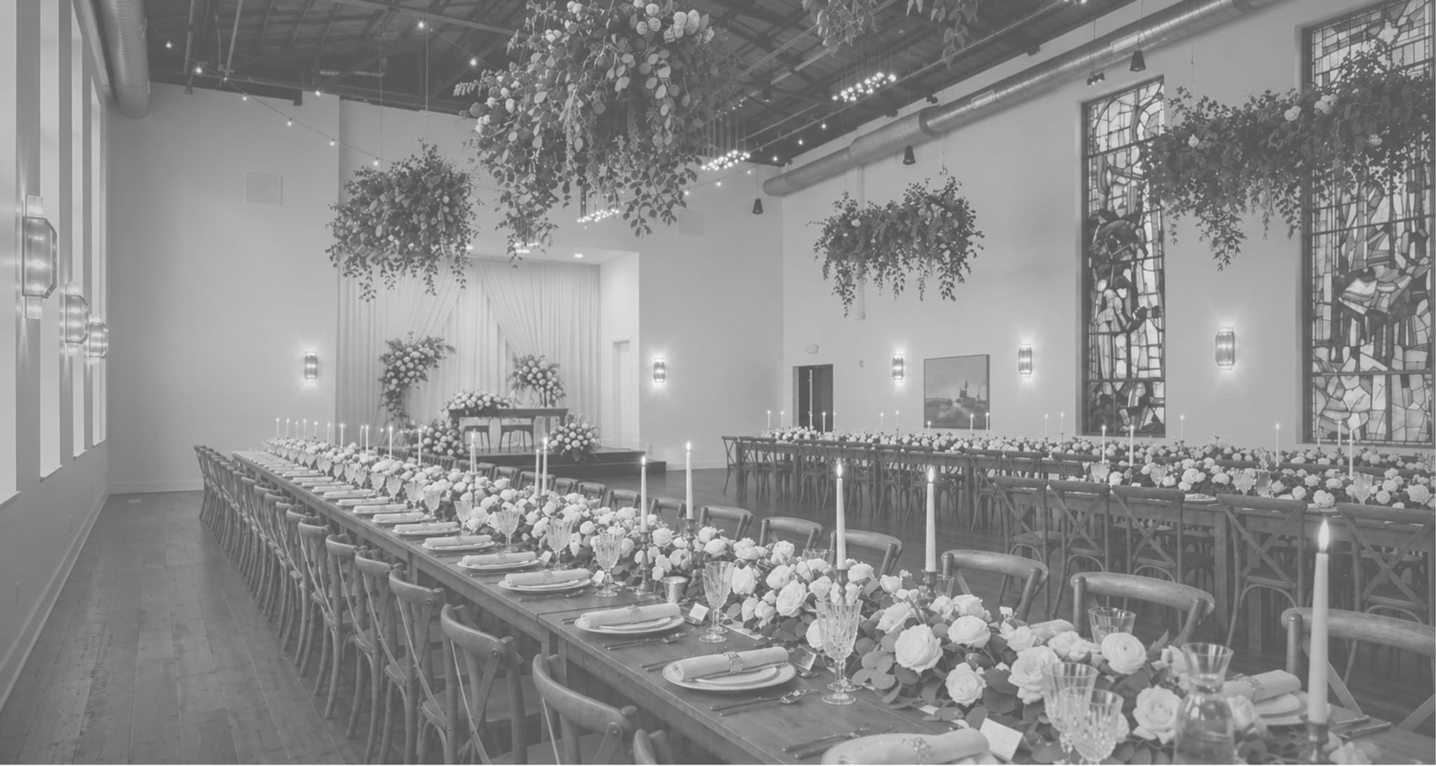 A long banquet table dressed with candles and florals in the Châtelet hall