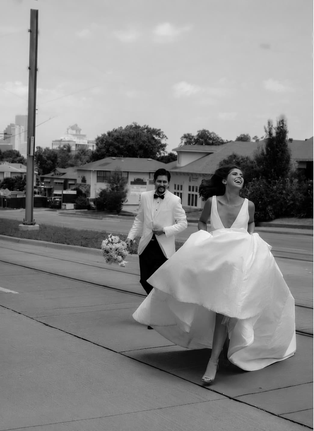 Newlyweds walking a Bishop Arts street after their ceremony